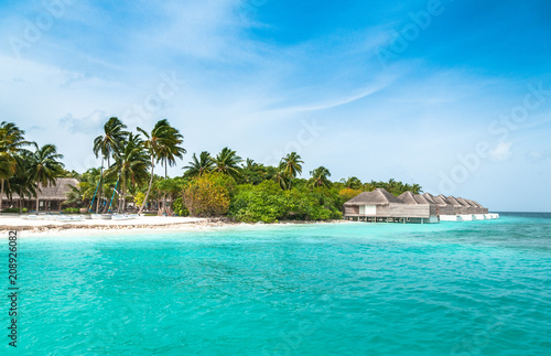 Tropical beach with palms on the background of the island