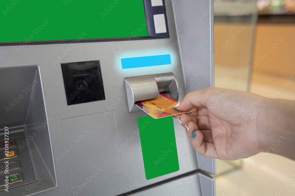 Woman hand used ATM card or credit card for withdraw money from ATM machine. Woman hand used ATM card or credit card for withdraw money from ATM machine.