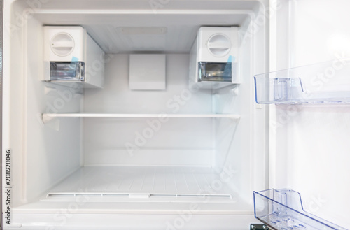 open empty new white refrigerator inside fridge with shelves .