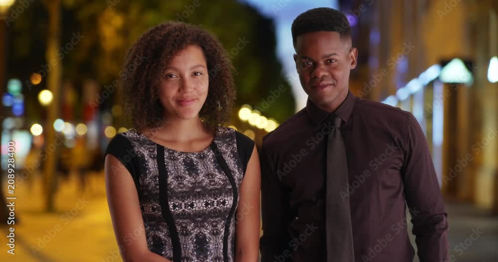 Happy business team pose for a portrait on Champs-Elysees avenue at night, Young millennial black male and female smiling and laughing on Paris street in evening, 4k Happy business team pose for a portrait on Champs-Elysees avenue at night, Young millennial black male and female smiling and laughing on Paris street in evening, 4k