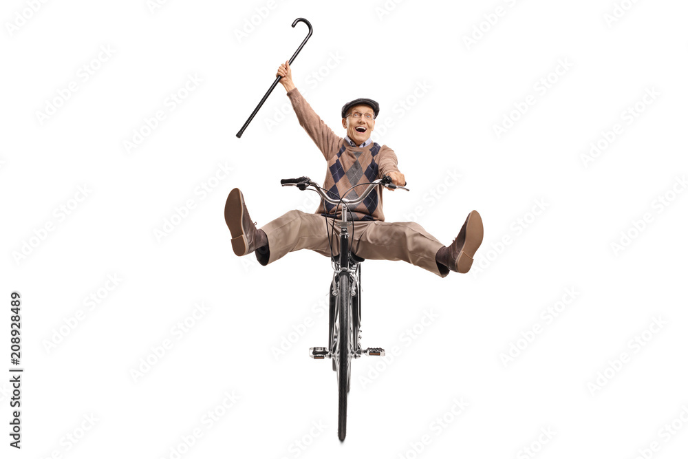 Naklejka premium Overjoyed senior with a cane riding a bicycle