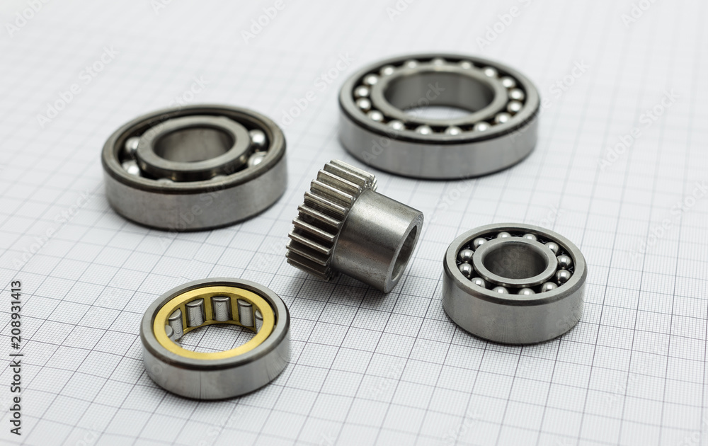 Bearing and small gear lying on drafting paper. Bearing and small gear lying on drafting paper.