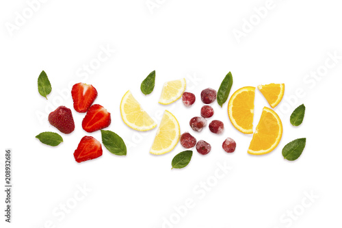 Fototapeta Naklejka Na Ścianę i Meble -  Colorful bright fruit, strawberry, cherry, lemon, orange, mint leaves on a white background light. Flat lay, top view