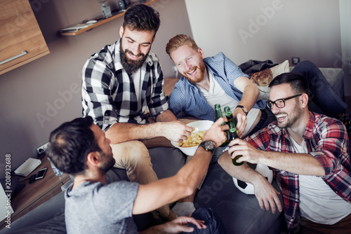 Happy male friends drinking beer