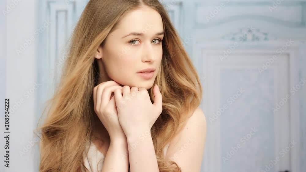 young blonde woman with long hair and natural look video portrait touching her face young blonde woman with long hair and natural look video portrait touching her face