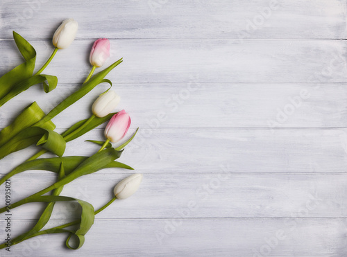 Bouqette of tulips on a wooden background. Top view. Greeting card photo