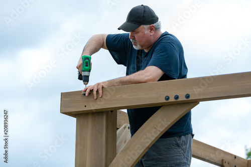 Mature man building wooden construction