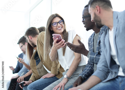 group of young people with smartphones