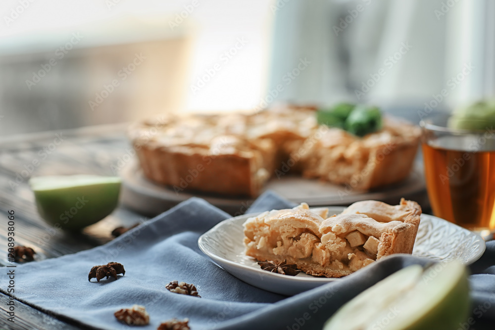 Plate with piece of tasty homemade apple pie on table Plate with piece of tasty homemade apple pie on table