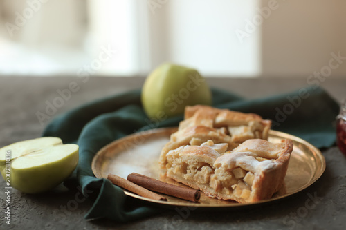 Plate with pieces of tasty homemade apple pie on table