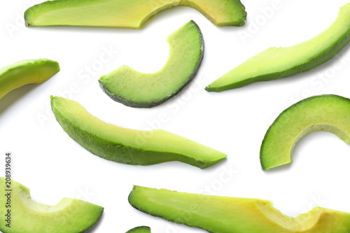 Slices of ripe avocado on white background