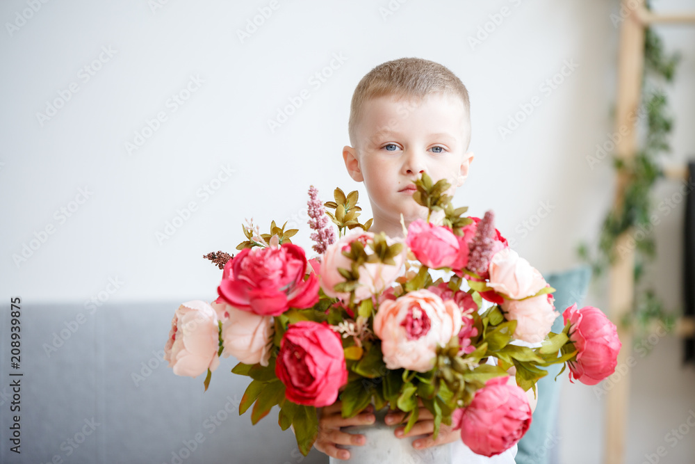 Photo of boy with bouquet of pink peonies Photo of boy with bouquet of pink peonies