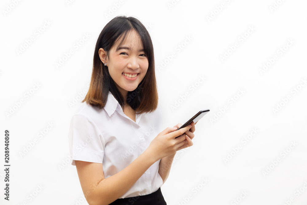 Smiling happy and cheerful Asian female formal dress holding a smart mobile phone isolated over white background. Smiling happy and cheerful Asian female formal dress holding a smart mobile phone isolated over white background.