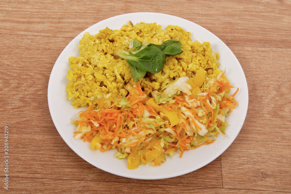 Baked Bulgar with cauliflower and vegetable salad on a table Baked Bulgar with cauliflower and vegetable salad on a table