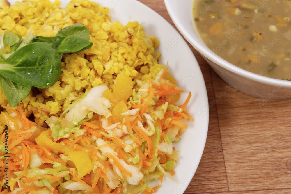 Baked Bulgar with cauliflower and vegetable salad on a table Baked Bulgar with cauliflower and vegetable salad on a table