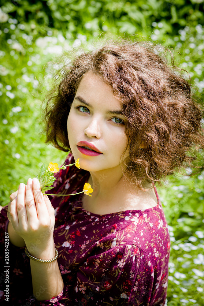 Portrait of an incredible girl with a flower in her hand Portrait of an incredible girl with a flower in her hand