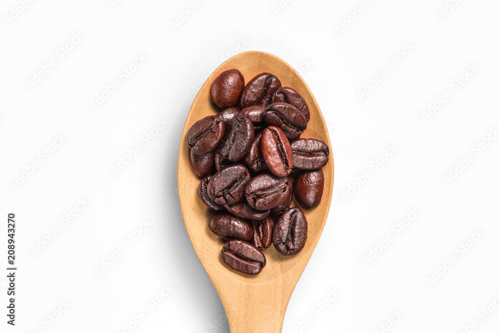 Fototapeta premium Top view of coffee bean on wooden spoon isolated on a white background.
