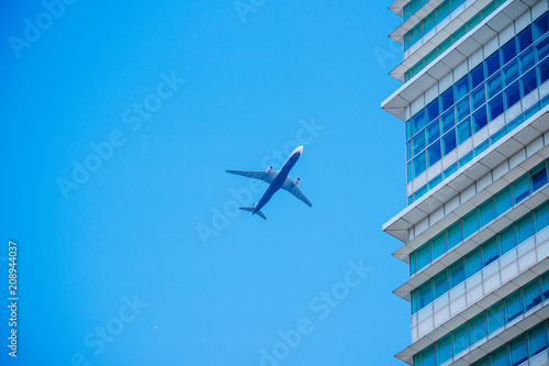 Airplane flying in the blue sky among clouds