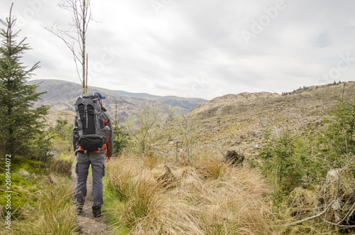 Backpacker Hiking through Hills © Walkerlee
