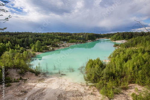 Flooded open pit quarry ore kaoline mining with blue water