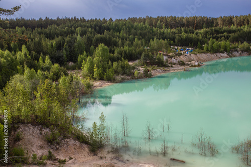 Flooded open pit quarry ore kaoline mining with blue water