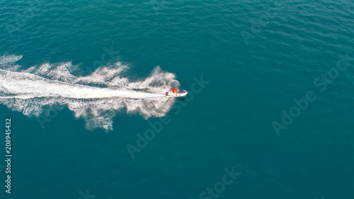 People are playing jet ski at sea during the holidays. Aerial view and top view.