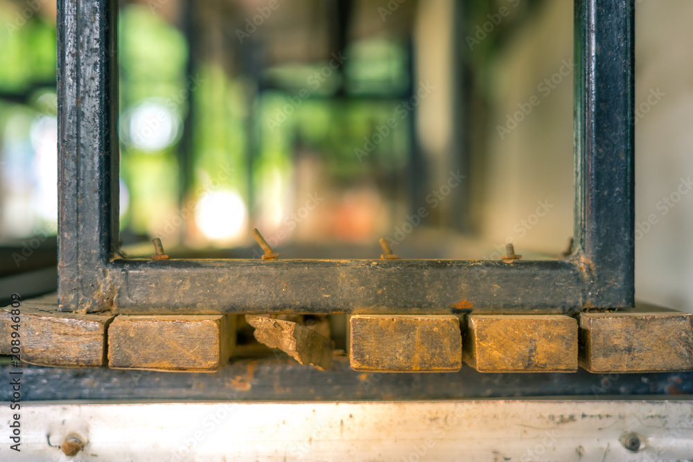 Old broken tables and chairs in school for sale.
