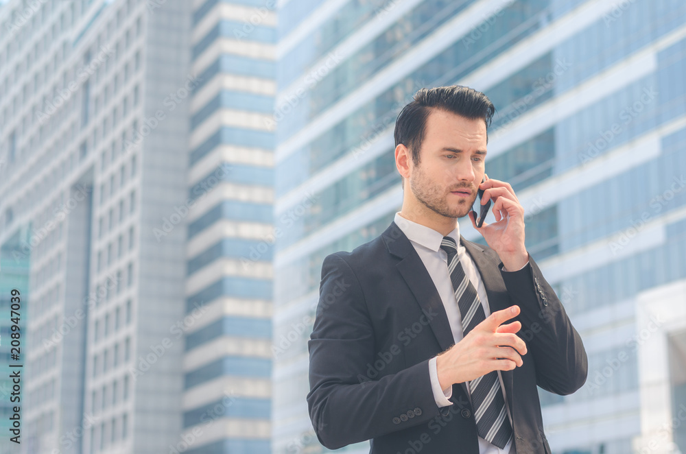 portrait attractive businessman manager in smart suit in city outdoor against building background using smartphone talking with cowerker. CEO. management development corporate. portrait attractive businessman manager in smart suit in city outdoor against building background using smartphone talking with cowerker. CEO. management development corporate.