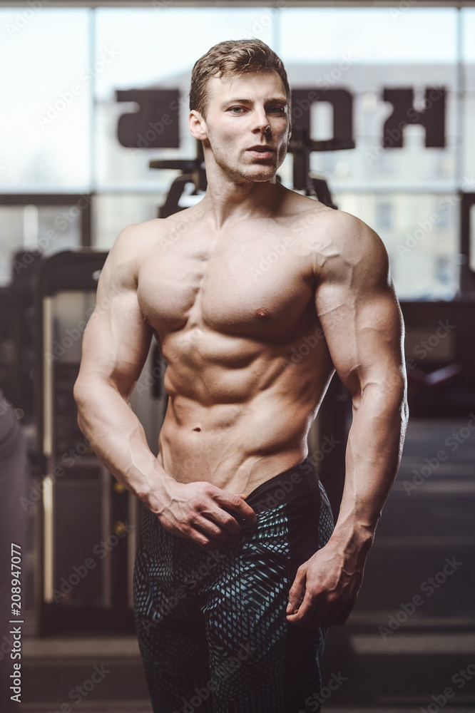 handsome strong bodybuilder athletic men pumping up muscles with dumbbells handsome strong bodybuilder athletic men pumping up muscles with dumbbells