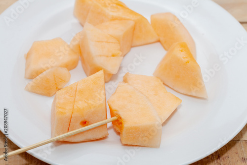 close up of sliced of melon on plate