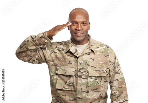Smiling African American Soldier Renders a Salute in Uniform