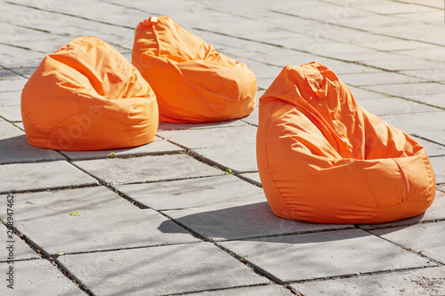 Fotografia Three coloroful orange beanbags chairs for relaxing outdoor