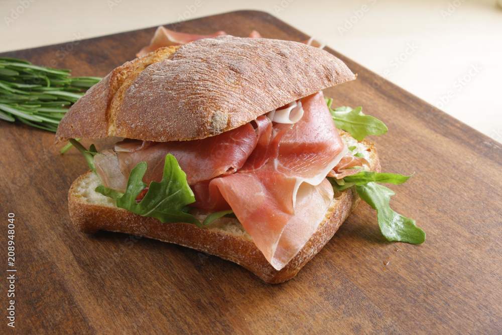 sandwich with prosciutto jamon on a wooden background sandwich with prosciutto jamon on a wooden background
