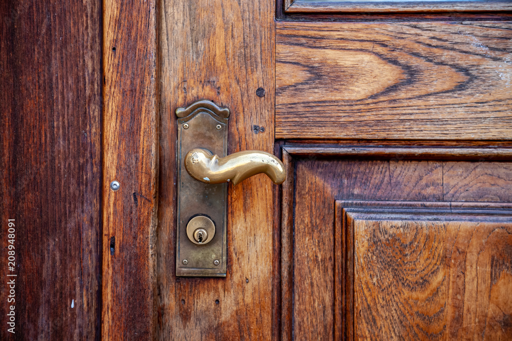 close up view of rustic wooden door with steel handle close up view of rustic wooden door with steel handle