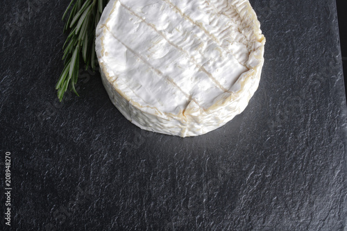 brie cheese on a stone background