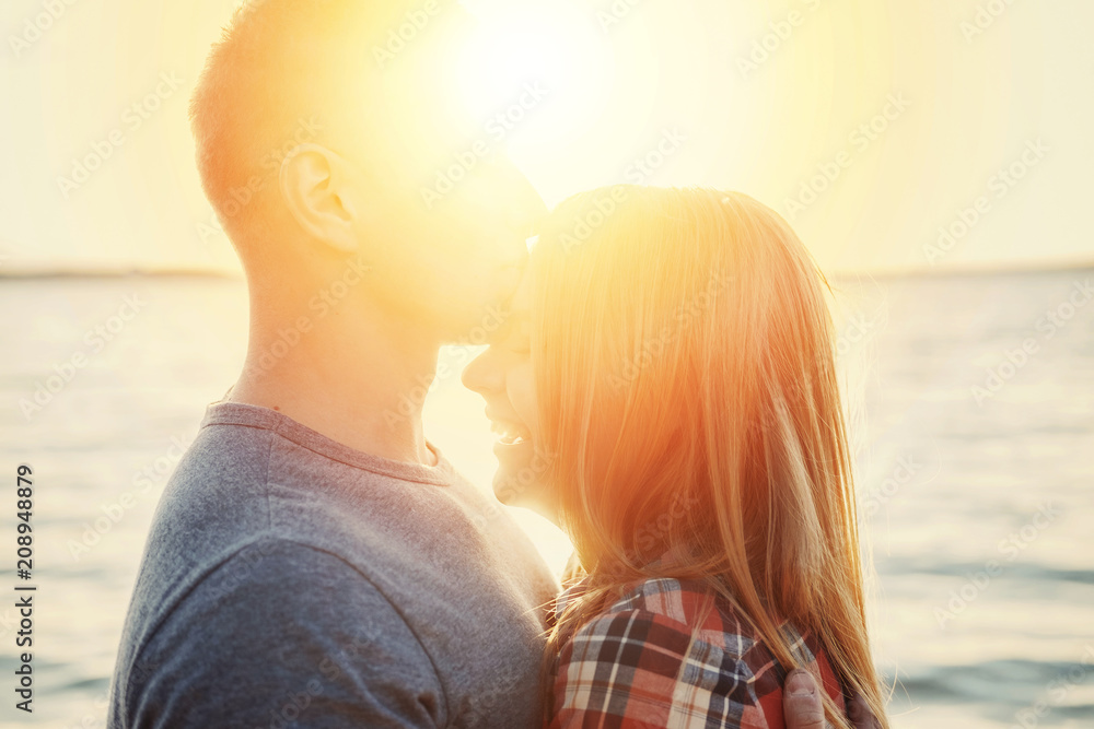 Fototapeta premium couple happy on the beach sunset romantic kiss close-up