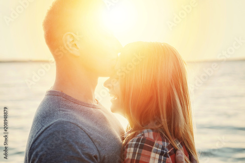 couple happy on the beach sunset romantic kiss close-up © denisval