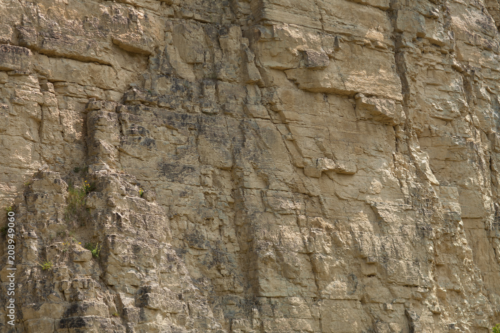 impressive huge steep wall in a surface quarry, stone texture, can be used as background