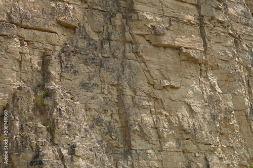 impressive huge steep wall in a surface quarry, stone texture, can be used as background
