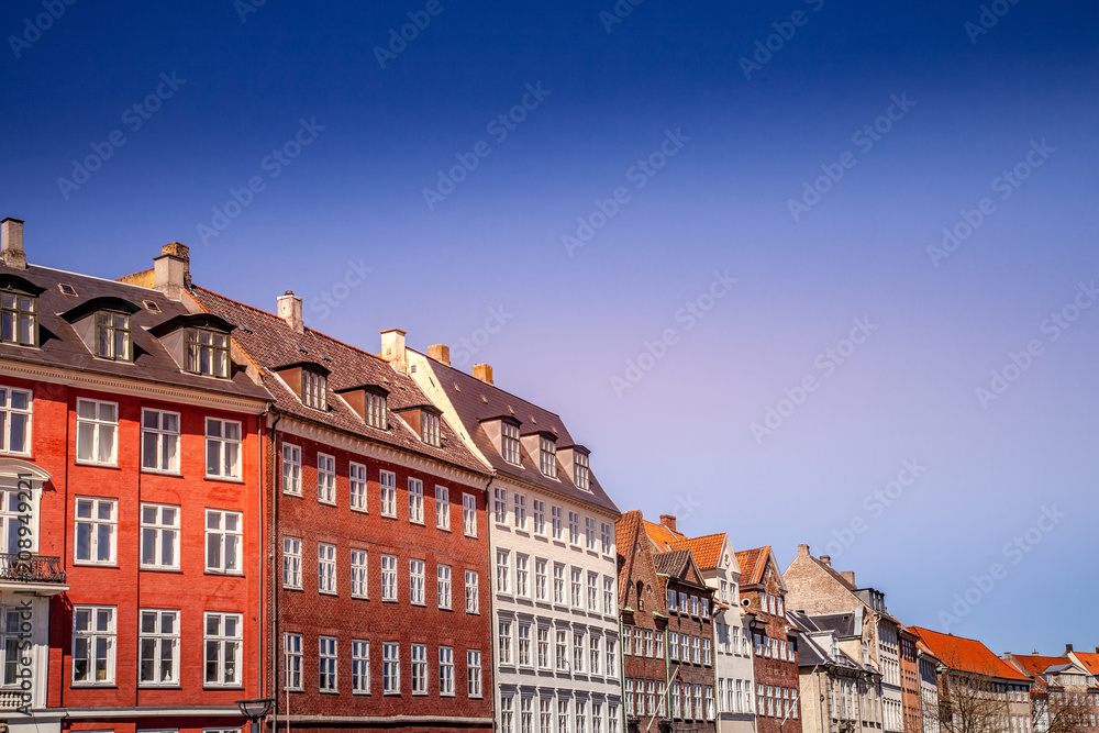 Urban scene with colorful buildings and clear blue sky in Copenhagen, denmark
