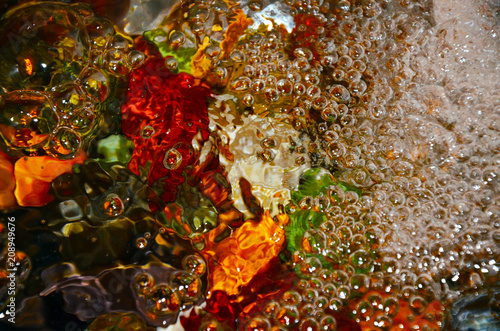 texture water bubbles multi-colored stones in bubbling water abstraction color