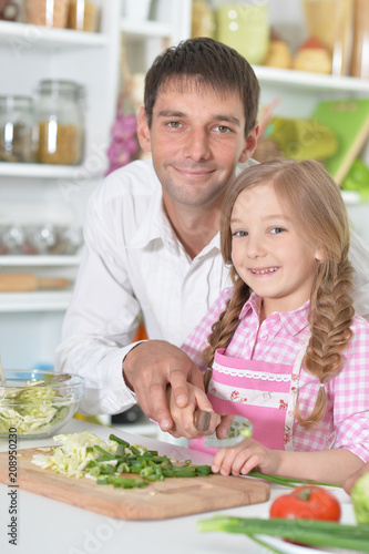 Father and daughter preparing salad
