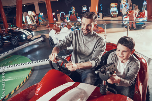 Smiling father and son in amusement center