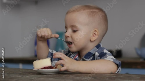 Wallpaper Mural Little old boy sitting at table, looking, enjoy with dessert. Close-up Torontodigital.ca