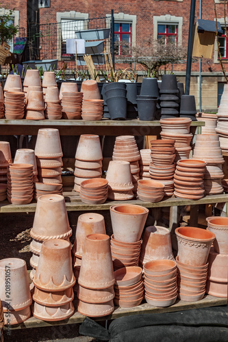 various handmade ceramic pots on shelves in copenhagen, denmark
