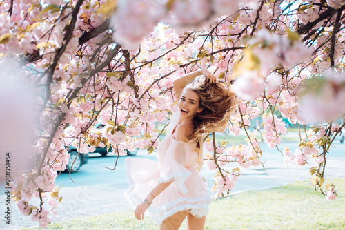 Spring woman in cherry flower bloom concept with girl sakura
