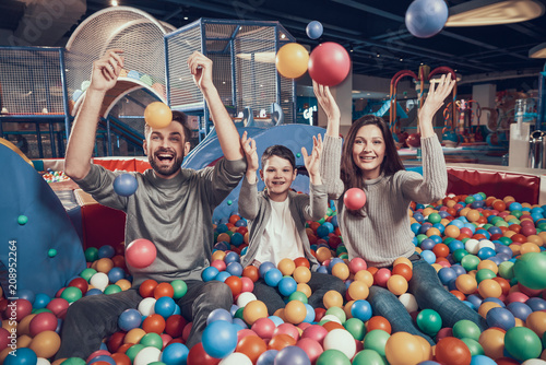 Happy family in pool with balls photo