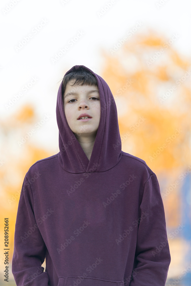 Portrait of a young attractive boy in red hood outdoors Portrait of a young attractive boy in red hood outdoors