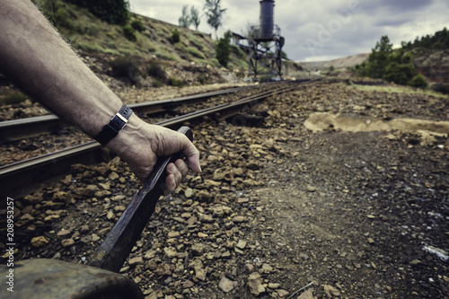hand pulling the lever to change the way in the old train station of Zaranda