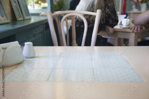 Table in a cafe In a blurry background, visitors